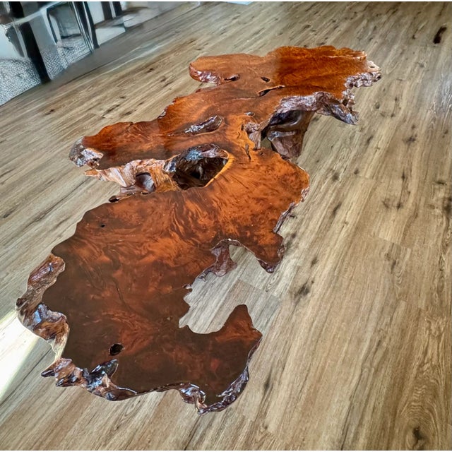 Striking live edge redwood table featuring a highly figured burl slab and sculptural natural base. The organic shape, rich...