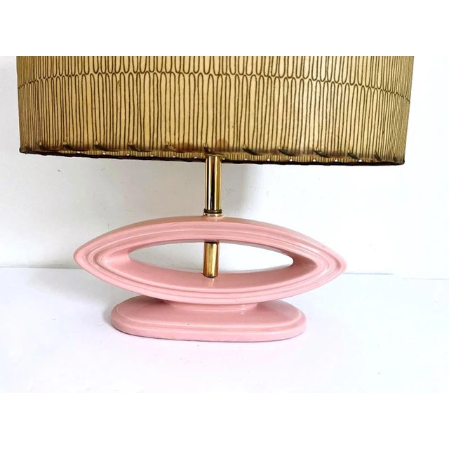 Chic modern open oval lamp of glazed dimensional blush pink ceramic with integrated oval base and the original squiggle...