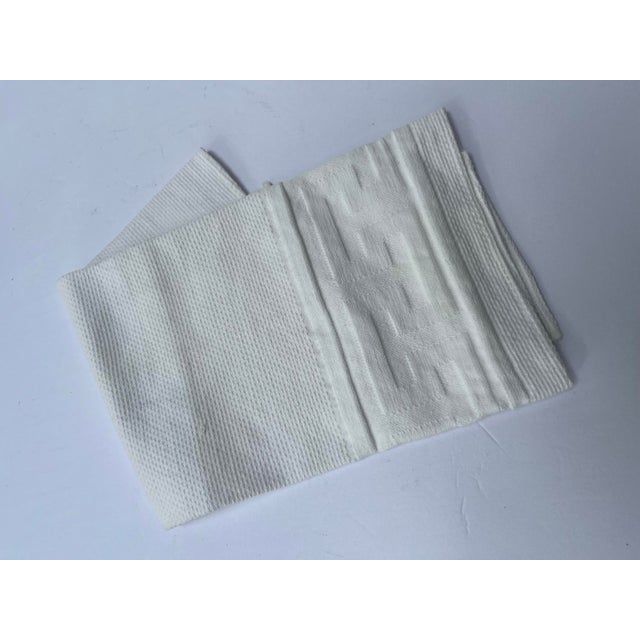 A single antique cotton hand towel with Greek key decoration.