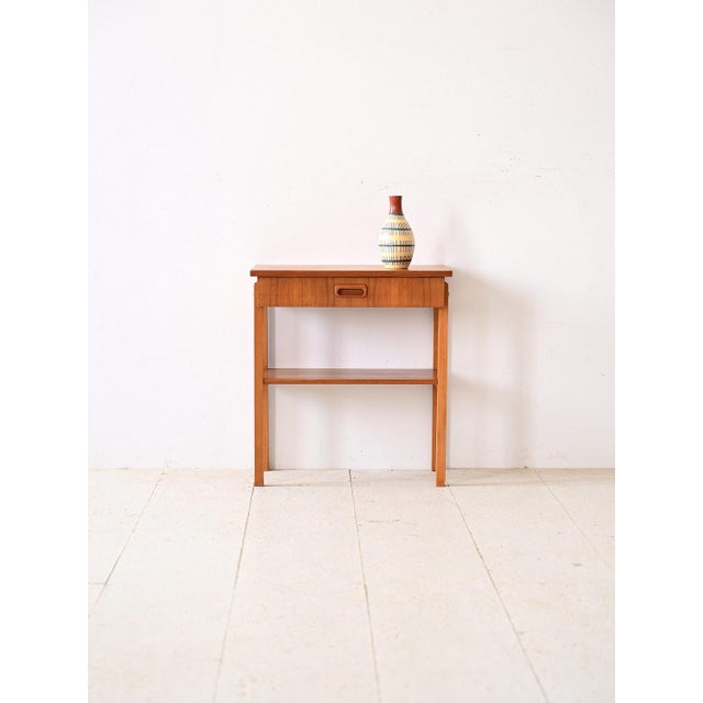 Vintage 1960s teak bedside table. A piece of furniture that captures the essence of retro design with a touch of elegance....