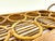 Mid-century rattan drink caddy featuring an integrated circular bottle rack with wrapped handles and warm honey-toned cane...
