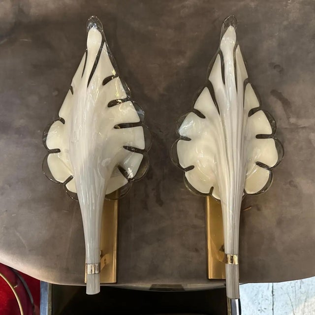 These are 1970s Mid-Century Modern wall sconces designed by Franco Luce. The sconces feature a striking leaf-shaped design...