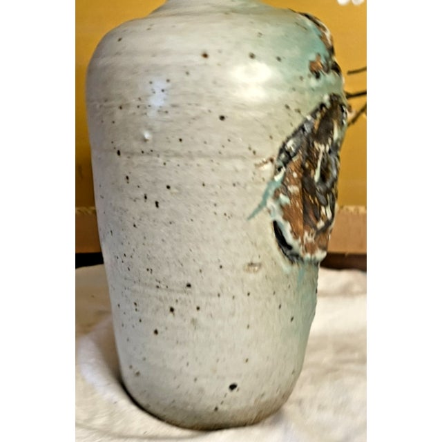 Modern interpretation of flowers with a speckled green glaze. No flaws detected.