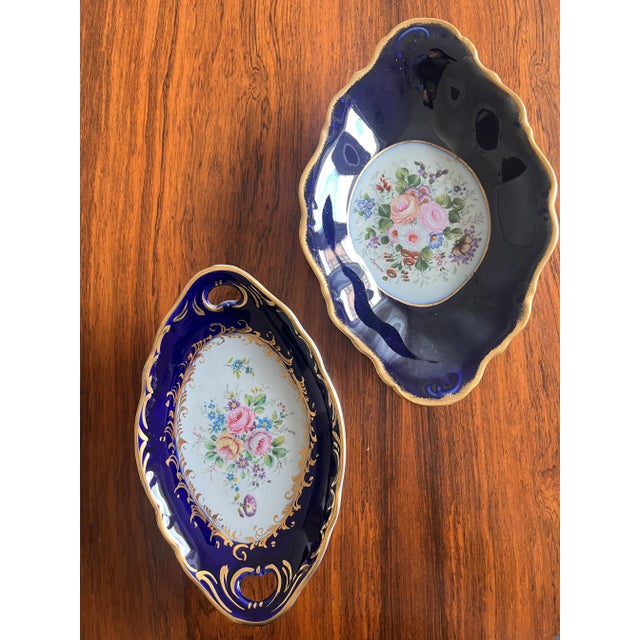 A pair of Limoges ceramic cake stands, hand-decorated and signed on the back. Intact and in perfect condition. Beautiful...