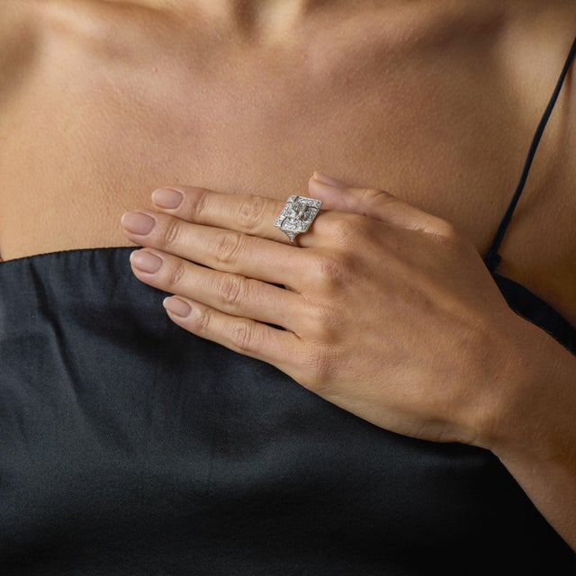 This exquisite Art Deco diamond ring captures the elegance, romance, and architectural beauty of the 1930’s. At its center...