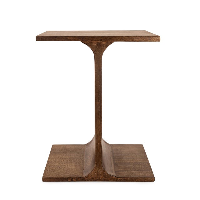 Crafted in a warm wood finish, this eye-catching piece features a triple-tiered base with minimalist column supports that...
