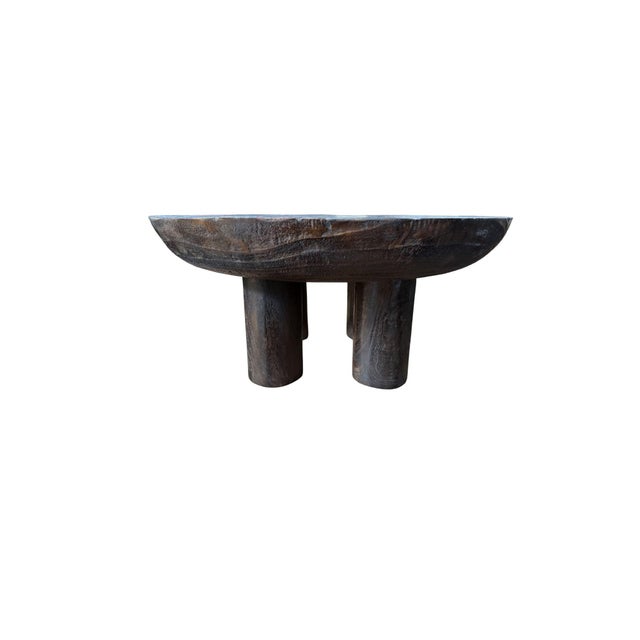 Bold in scale and quietly monumental in form, this sculptural coffee table is handcrafted from solid suar wood and...