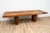 Bagutta dining table by Henk Vos. The tabletop is inlaid with various types of wood on large solid wooden legs. This piece...