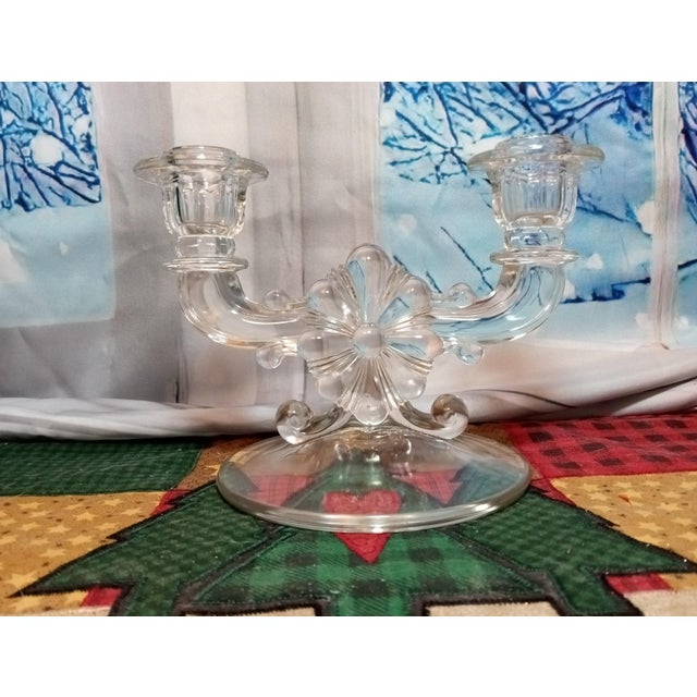 Vintage Indiana Glass clear pressed glass candle holder. It's about 5 1/2" tall 7 1/2" wide. It is a double candle holder....