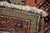 Vintage hand-knotted tribal area rug featuring a richly patterned salmon field with deep indigo medallions and intricate...