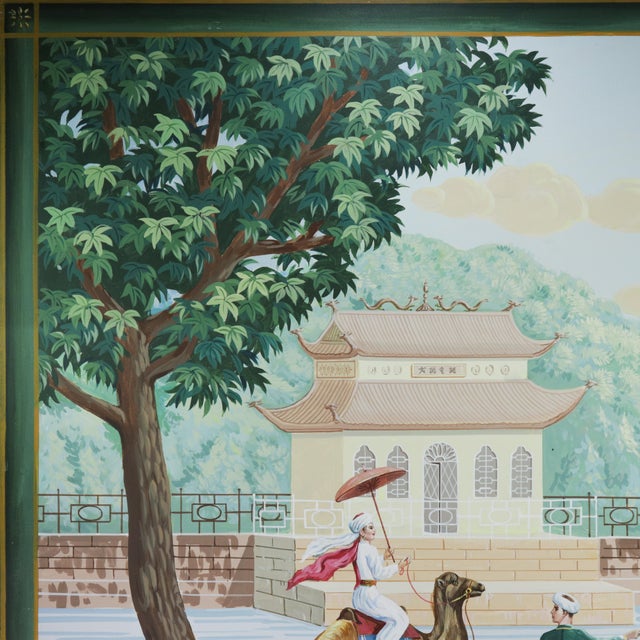 This striking vintage chinoiserie painting features a serene and imaginative landscape with a camel rider and a richly...