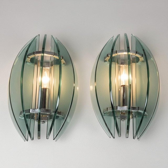 A refined pair of wall lamps (sconces), an unmistakable creation by the Italian company Veca, dating back to the 1970s....