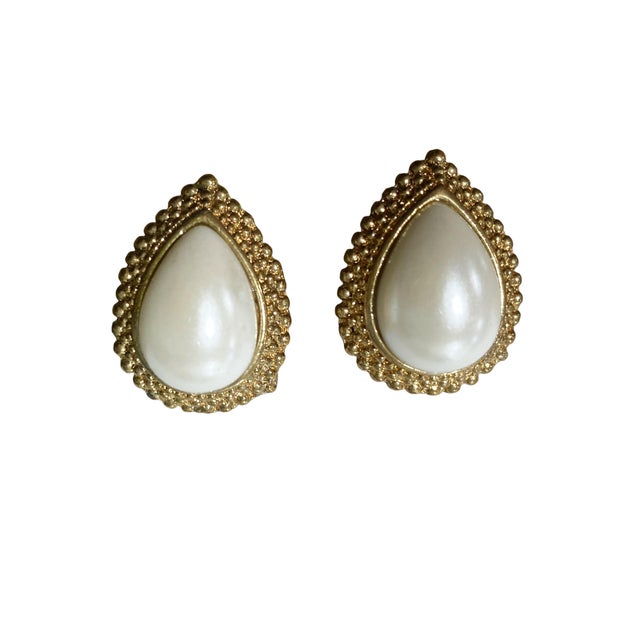 This elegant pair of earrings features a vintage design with a large faux pearl pear shape at its center , gold tone ,...