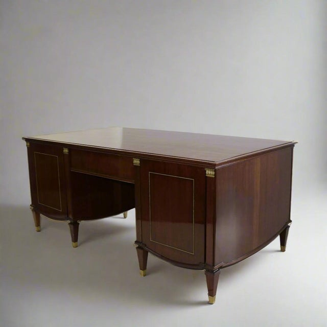 A Neoclassical style desk by De Coene Frères from Brussels, Belgium circa 1940. Constructed of beautiful hardwood with...