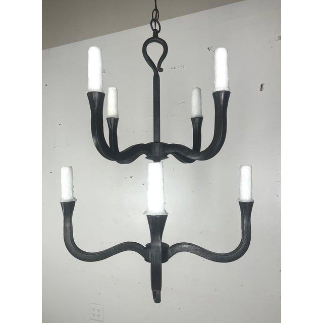 Custom two-tier wrought iron chandelier by Melissa Levinson. This chandelier has a classic, elegant structure. It has...