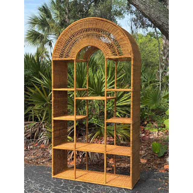 Bring timeless coastal charm to your home with this beautiful 1970s vintage wicker étagère. Featuring a gracefully arched...