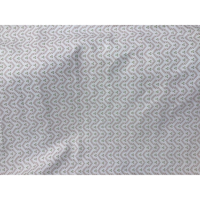 Wynford Blush Small scale blush pink curved, wavy dashes with accenting green dots. Measures 1.75 yards