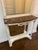 Elegant French antique marble top console table with removable mirror. This piece features carved columns, beveled...