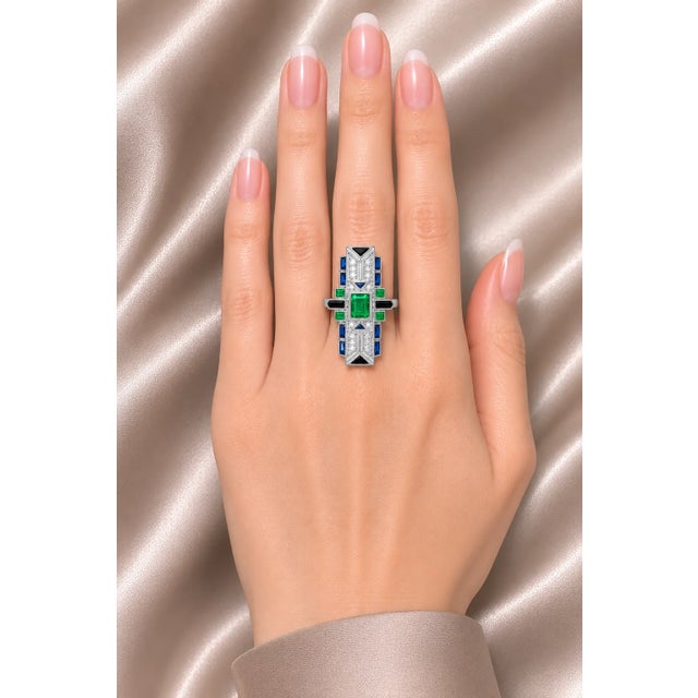 Stunning 18K white gold Art Deco mosaic statement ring featuring a natural emerald centerpiece, accented with hand-cut...