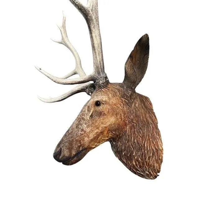 A magestic Black Forest stag head. Rustic patina from hanging outdoors. Has glass eyes.