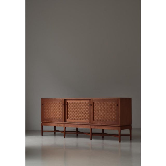 Exceptional large sideboard designed by Ilse & Ove Rix in Denmark during the 1960s, exemplifying the warmth and material...