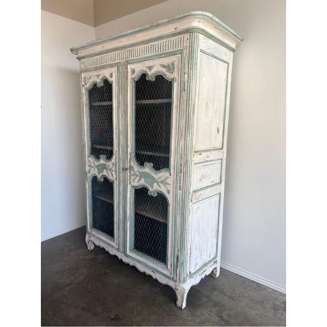 19th C. French painted Armoire w/ chicken wire. The armoire is painted in shades of aqua marine and antique white. You can...