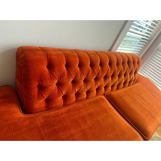 Large armless sofa with tufted back and original orange textured velour. Very good+ original condition, small, 2" tear...