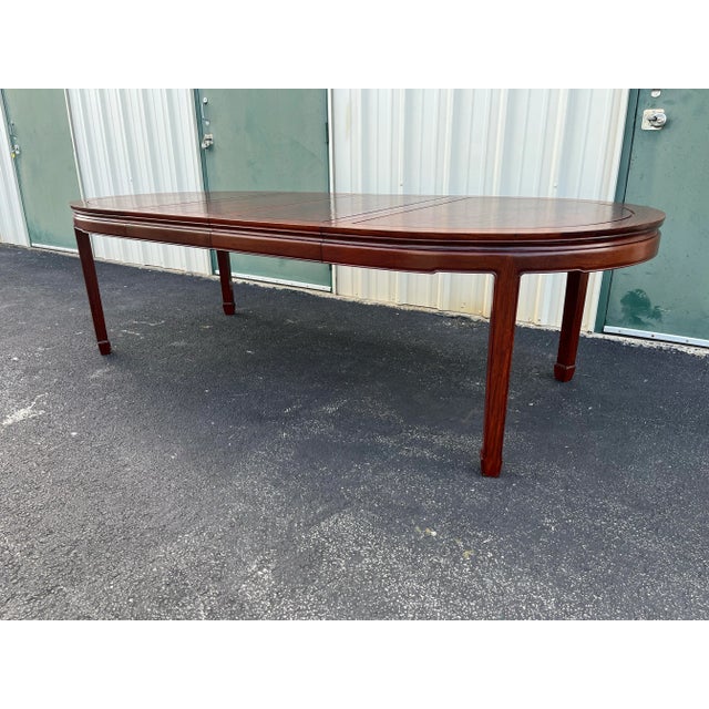 Solid rosewood extension dining table in excellent condition. This dining table is clearly from Asian origins and features...