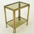 Mid Century Italian made side tables made of a brass frame and smoky glass shelves. Good condition with surface wear and...