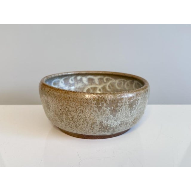 A finely crafted studio ceramic bowl by Helma Klett (1908-1996) with a striking, crystalline-looking flowing glaze on the...
