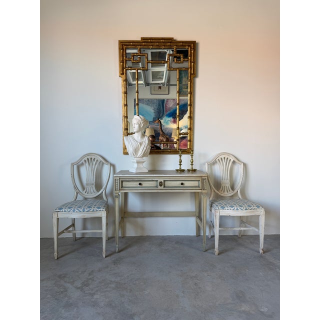 Elegant vintage French Provincial / Gustavian style writing desk featuring a distressed cream painted finish with soft...