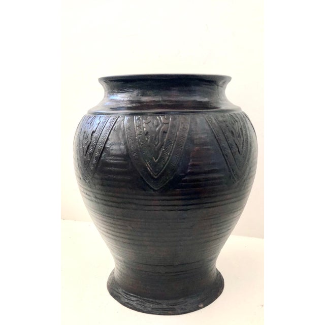 An antique, heavy bronze vase from Kyoto Japan. Used for Ikebana or flower arrangements in a Buddhist temple. An...