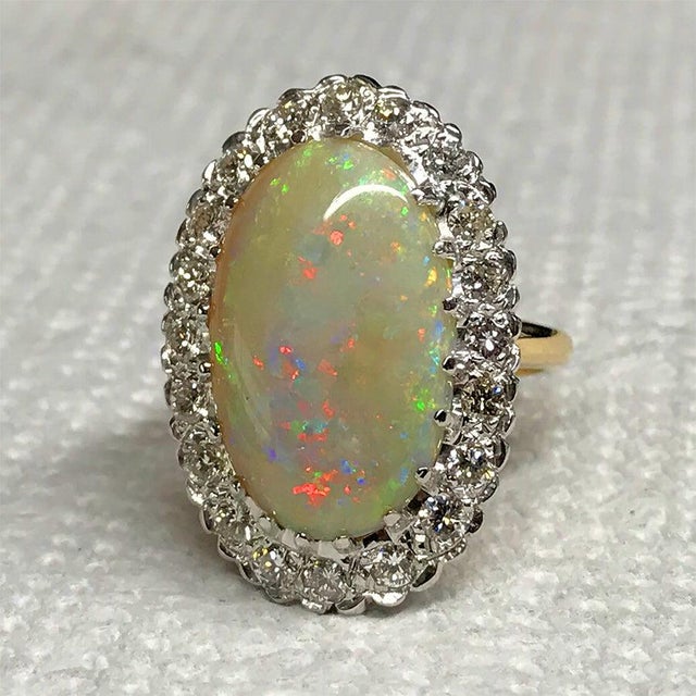 14k Ring with 7.94 carat Austrailan opal and 20 round diamonds weighing 1.04 carats 7.78 grams.