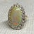 14k Ring with 7.94 carat Austrailan opal and 20 round diamonds weighing 1.04 carats 7.78 grams.