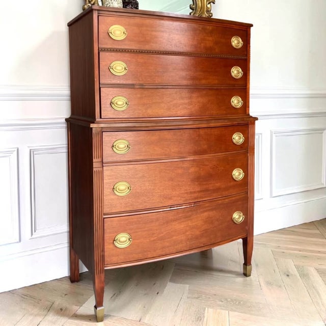 Rich mahogany, graceful curves, and timeless Federal styling come together in this beautiful chest. Featuring a bow front,...