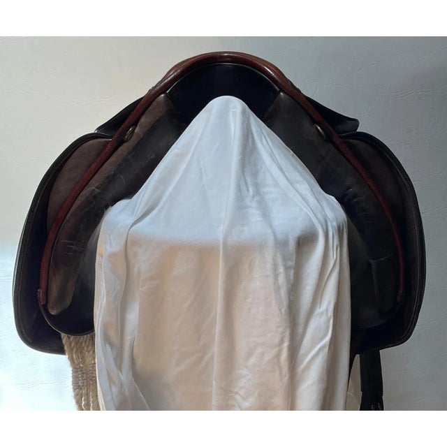 This is a handsome, handmade, very lightly used 18” deep brown jumping saddle Lauriche serial #2193. It has black metal...