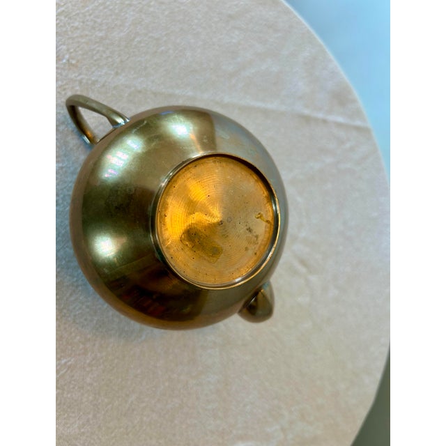 A small brass pot that will add charm and whimsy to any serving tray.