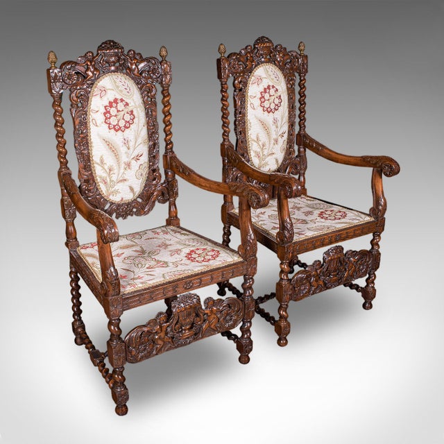 This is a pair of antique Charles II revival armchairs. An English, carved beech elbow seat, dating to the Edwardian...