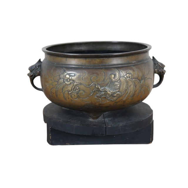 A large and impressive antique Chinese bronze Temple censer bowl on stand featuring a Phoenix on one side and Dragon on...