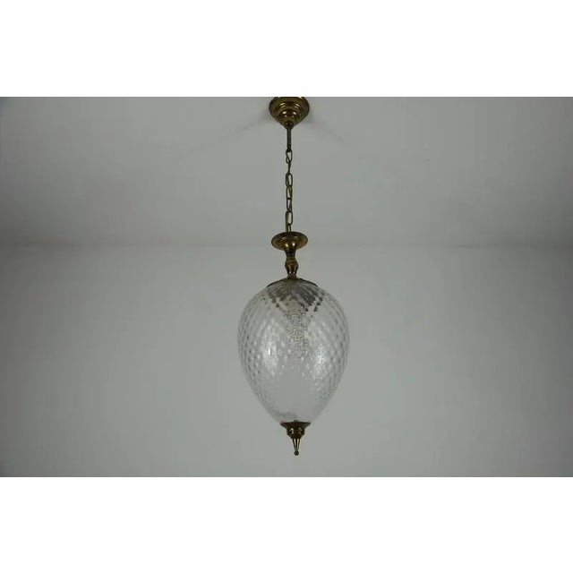 This elegant mid-century pendant lamp from italy, dating to the 1960s, beautifully combines brass and glass in a timeless...