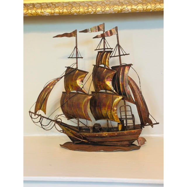 Vintage handcrafted metal sailing ship sculpture featuring a fully rigged three-masted vessel with sculpted copper-toned...