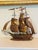 Vintage handcrafted metal sailing ship sculpture featuring a fully rigged three-masted vessel with sculpted copper-toned...