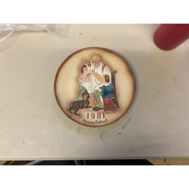 Set of three vintage 1981 Norman Rockwell “Plate Americana” decorative wall plates, each featuring a classic Americana...