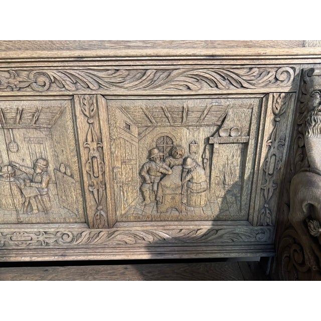 A great French Carved Oak Bench having the desired tavern scene panels. Lift up lid for storage. The lions on the arms are...