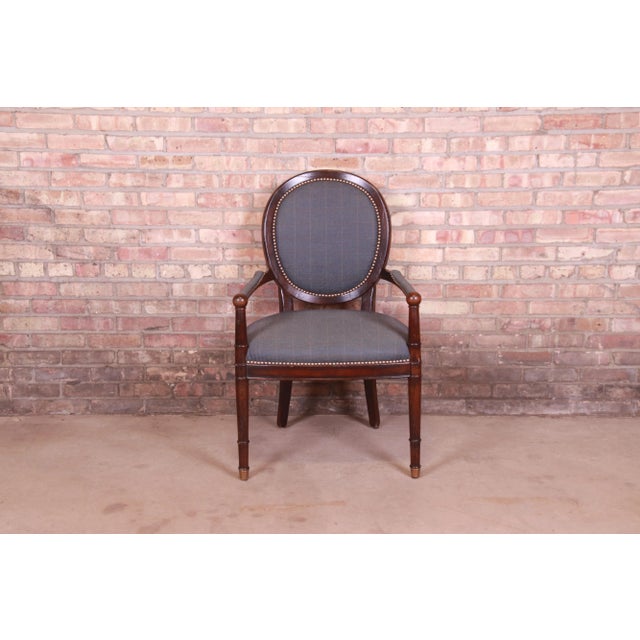 A beautiful French Provincial Louis XVI style arm chair or club chair By Baker Furniture USA, Late 20th Century Carved...