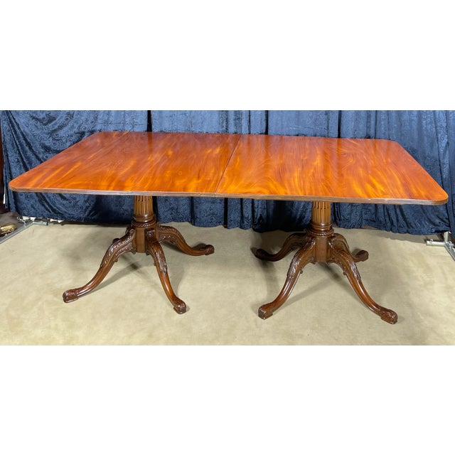 The table has a satin flame mahogany, wood-grain finish with a warm, amber hue that highlights its natural patterns. This...