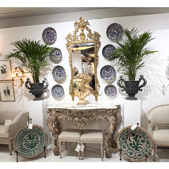 An elegant, Italian mirror, finely carved with beautifully aged original giltwood and original mirror plate. Carved urn...