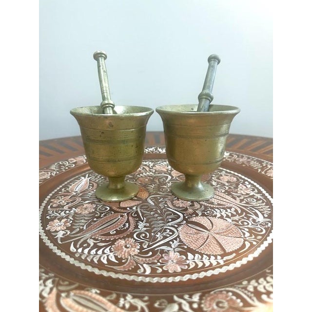 Pair of Vintage Brass Mortar and Pestle Set w/Distinctive Pedestal Base and Grooved Bands. Slightly different pieces. The...