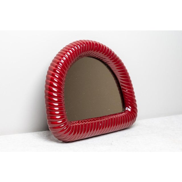 Segmented mirror in the style of Tommaso Barbi, Made in Italy, 1970s. Elegant segmented mirror with turned edge made of...