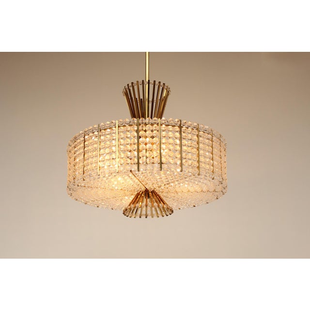 Vintage/Design Modern chandelier, made in Austria in the 1960s. Brass, steel tubing, and acrylic glass. The octagonal...